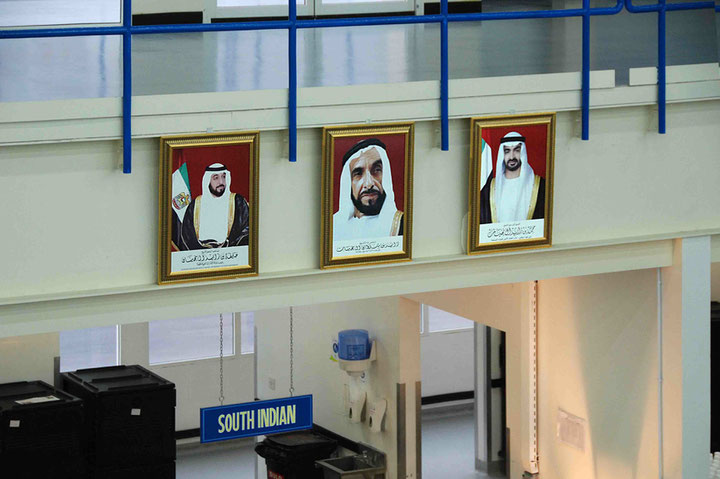 Portraits of Sheikh Khalifa bin Nahyan, the late Sheikh Zayed bin Sultan Al Nahyan and Sheikh Mohammad Bin Zayed Al Nahyan at the TDIC workers' housing estate on Saadiyat Island, Photo: ©Hans Haacke/VG Bild-Kunst, Abu Dhabi, 28.06.2010