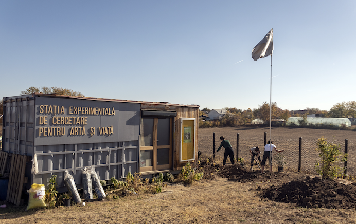 Container von studio BASAR, Flagge von Marx Machines Inc. (Filip Herbert, Anna Olszewska), installiert im Rahmen des Projekts „Lectures onthe Weather“, kuratiert von Anna Smolak, 2022; Bepflanzung des Kosmos-Gartens, 29. Oktober 2022, Foto: Catrinel Toncu
